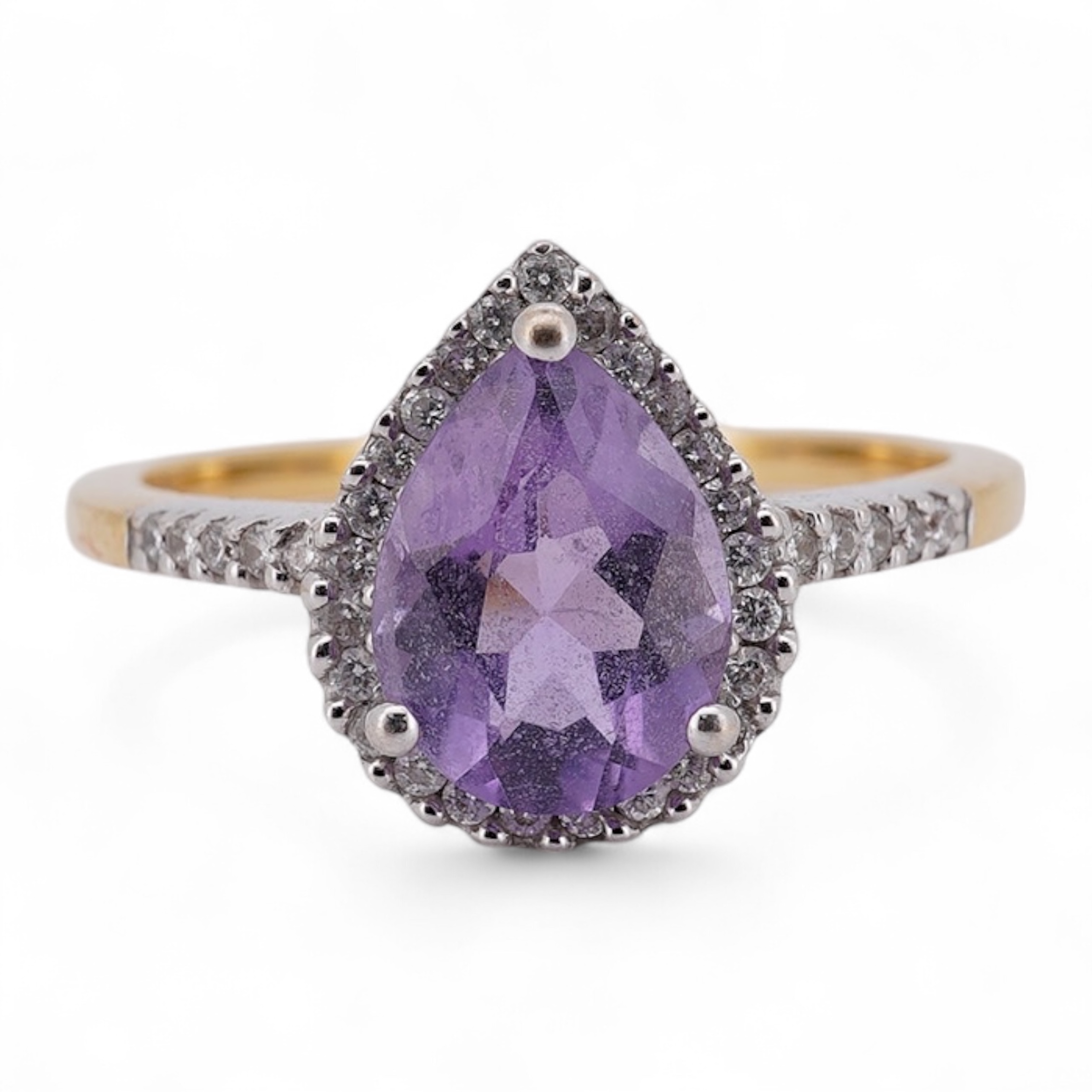A modern 18ct gold and single stone pear cut amethyst set ring, with diamond chip set border and shoulders, size O, gross weight 3.4 grams. Condition - fair to good